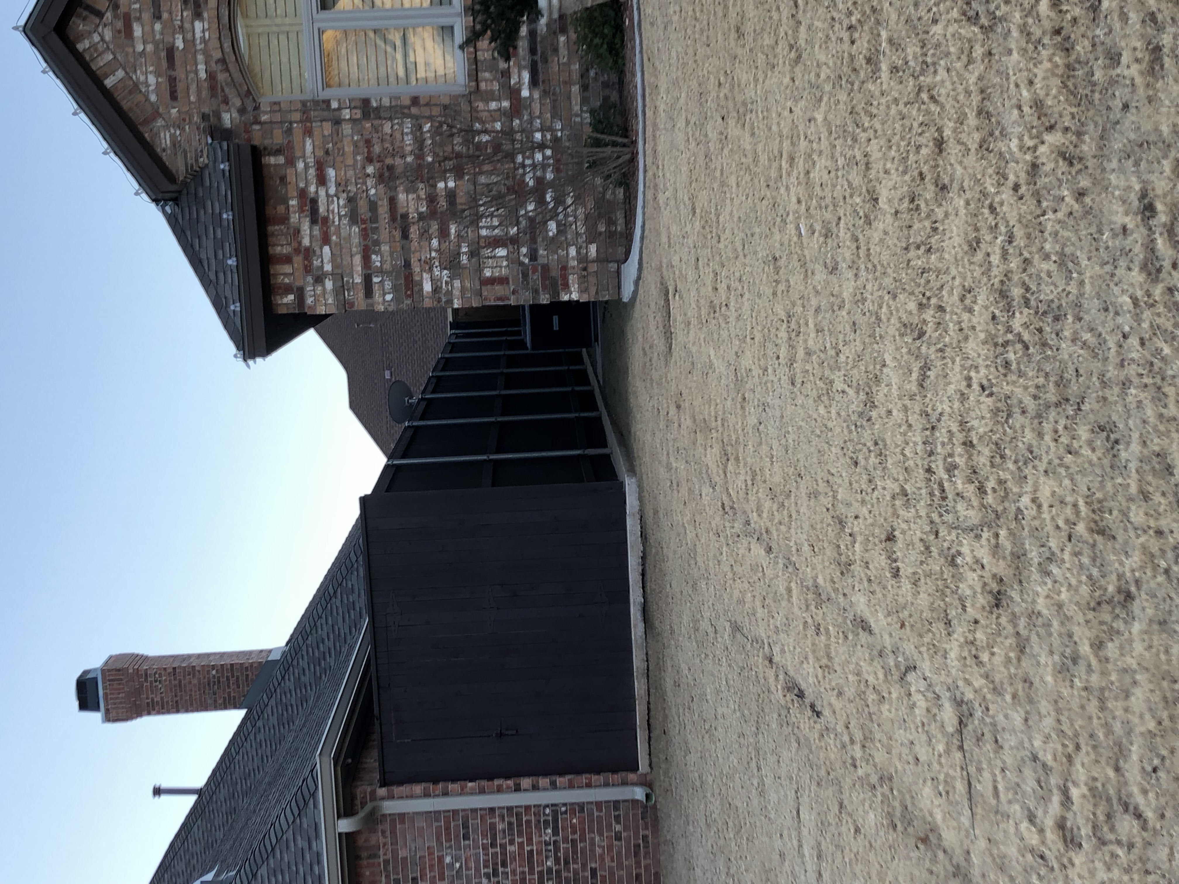 Dark stained wood fence with a rich finished color