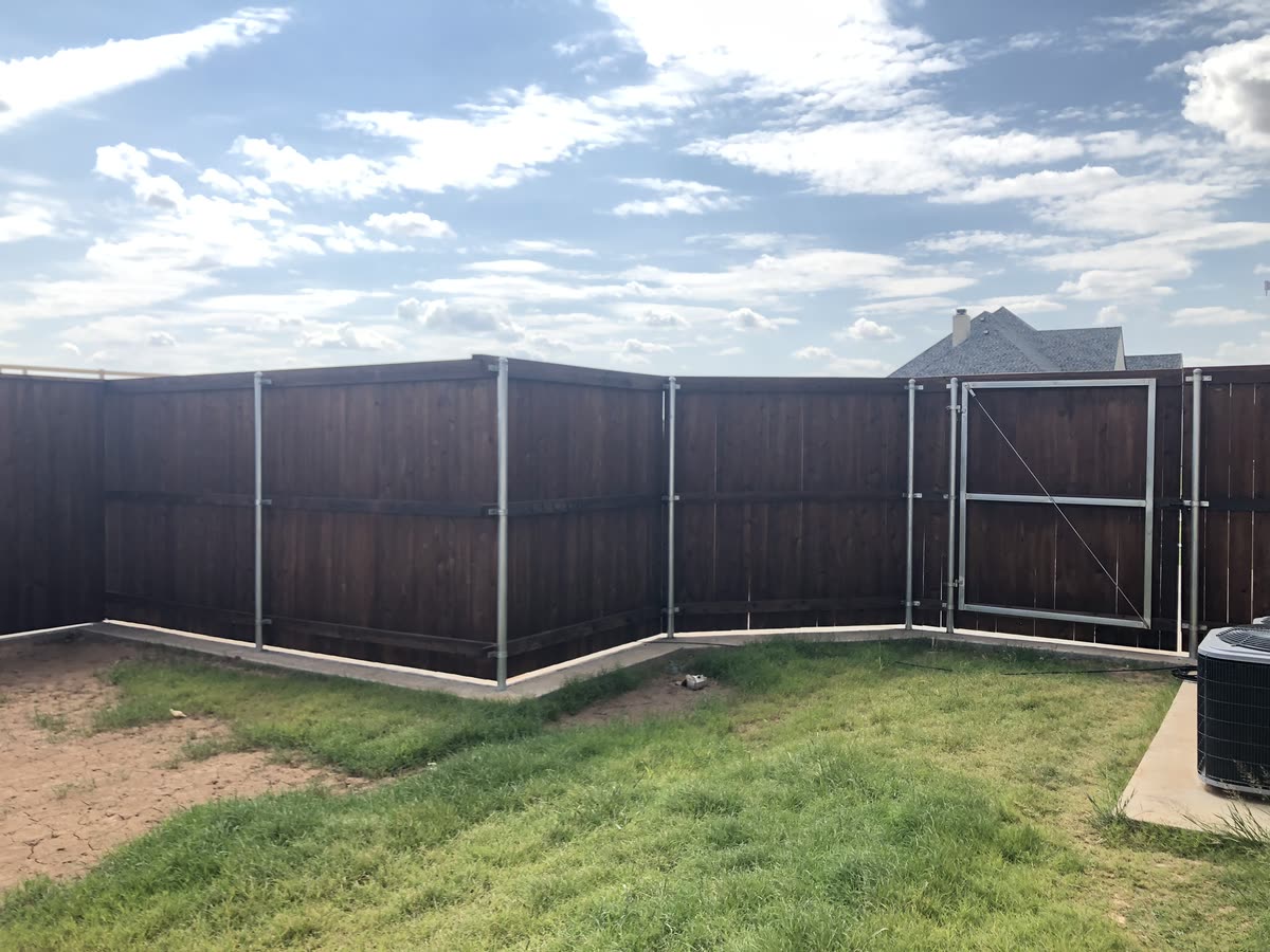 New wood privacy fence installed along a residential property line
